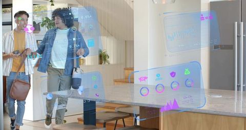 Young professionals walking through open-plan kitchen viewing augmented reality dashboards