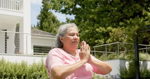 Senior Woman Practicing Outdoor Yoga Showing Mindfulness