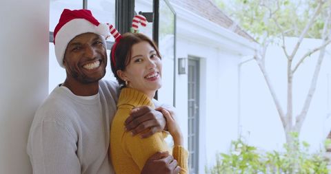 Happy Couple Embracing Near Window During Holiday Season