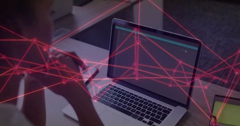 Hispanic woman studying code on laptop with digital overlay