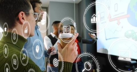 Team Analyzing Data with Digital Interface in Conference Room