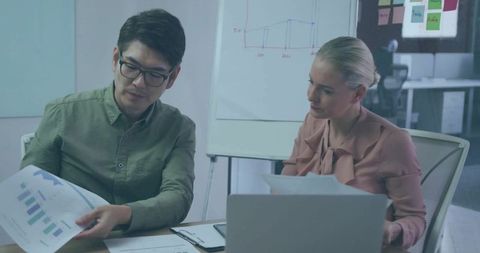 Colleagues Analyzing Data in Modern Office Meeting