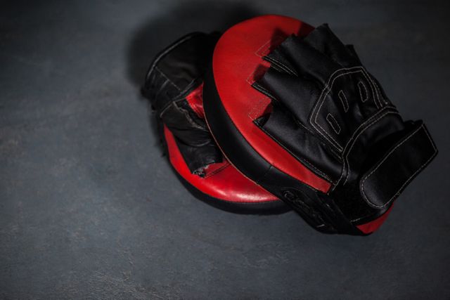 Close-up of boxing gloves and focus mitt in fitness studio