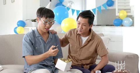 Father and Son Celebrating Birthday with Gifts and Smiles
