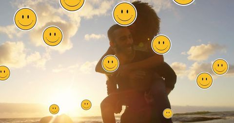 Joyful African American Couple on Beach Surrounded by Emojis