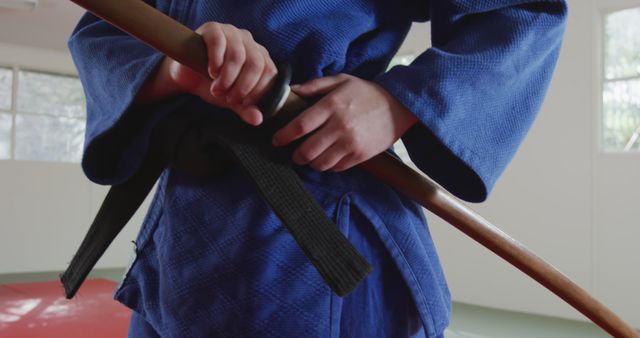 Person in Blue Gi Practicing Martial Arts with Wooden Sword - Download Free Stock Images Pikwizard.com