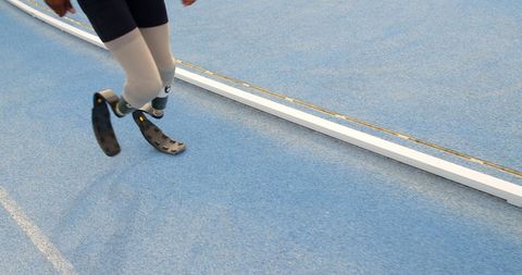 Adaptive Athlete Running with Prosthetic Blades on Track