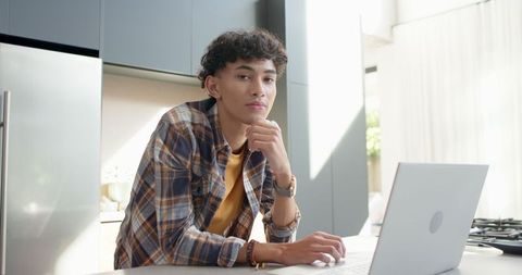 Young Asian Professional Focused Working at Modern Kitchen