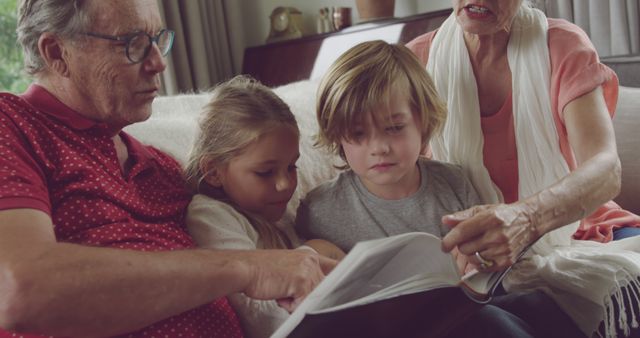 Grandparents Reading Book with Grandchildren on Couch - Download Free Stock Images Pikwizard.com