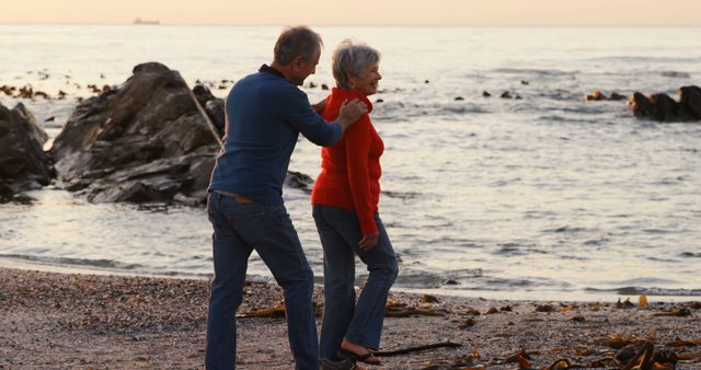 Senior Couple Enjoying Evening Walk on Beach - Download Free Stock Images Pikwizard.com