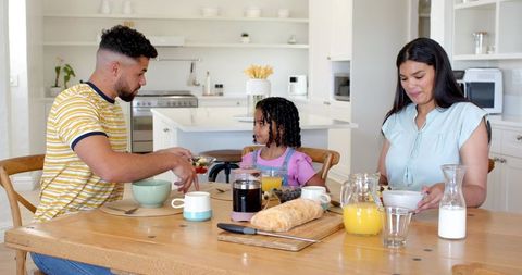 Family Sharing Breakfast Together in Modern Kitchen