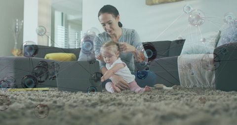 Mother guiding baby at laptop with digital network overlay, work-from-home parenting