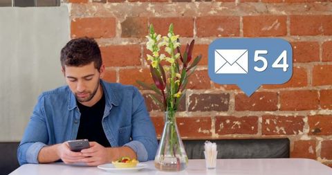 Young man checking smartphone in trendy cafe