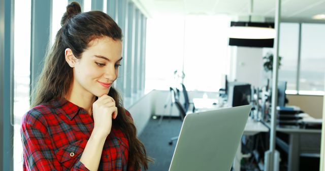 Young Professional Woman Using Laptop in Modern Office - Download Free Stock Images Pikwizard.com