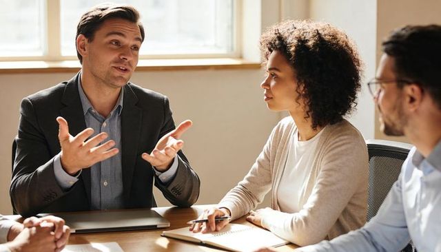 Business leader presenting strategy while diverse team listening and taking notes
