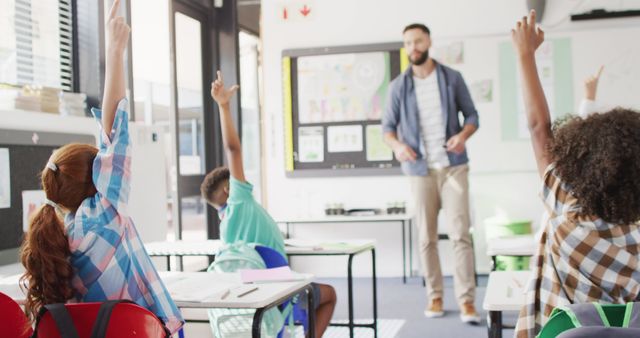 Teacher Engaging with Diverse Students Raising Hands in Bright Classroom - Download Free Stock Images Pikwizard.com