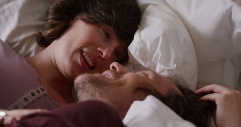 Couple Enjoying Intimate Conversation in Cozy Bedroom