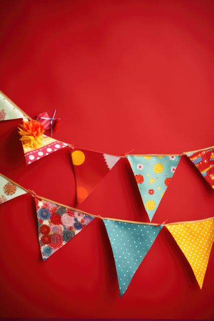 Strings of bunting on red background, created using generative ai technology. Birthday, party and celebration concept digitally generated image.