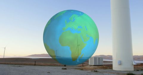 Renewable energy concept with rotating globe and wind turbines