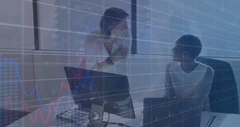 Businesswomen Analyzing Financial Data in Modern Office Setting