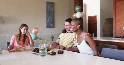 Friends gathering at home sharing snacks and stories