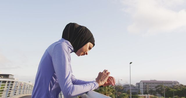 Woman in Sportswear Checking Fitness Tracker on Urban Bridge - Download Free Stock Images Pikwizard.com