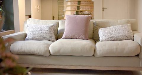 Cozy Beige Sofa with Pastel and Patterned Pillows in Modern Living Room