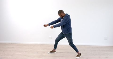 Male Dancer Practicing Moves in Minimalist Room