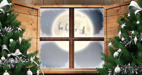 Santa in Sleigh with Reindeer Silhouette Against the Moon