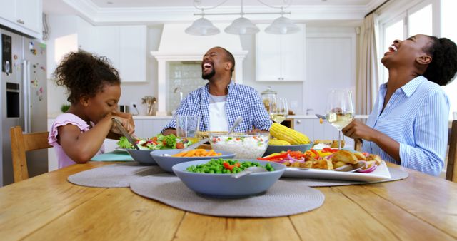 Family Sharing Joyful Meal in Bright Kitchen - Download Free Stock Images Pikwizard.com