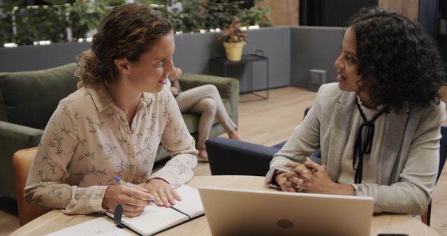 Two Businesswomen Discussing Work in Modern Office - Download Free Stock Images Pikwizard.com