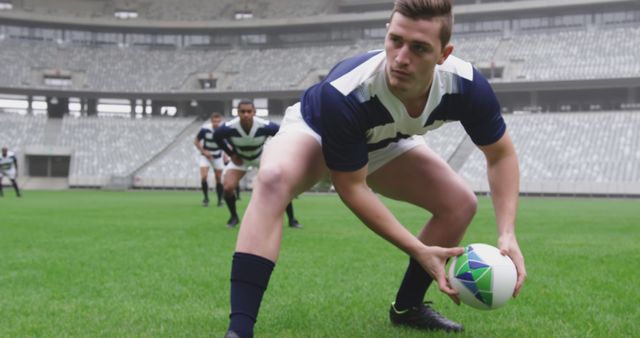 Focused Rugby Player Preparing to Pass Ball in Stadium - Download Free Stock Images Pikwizard.com