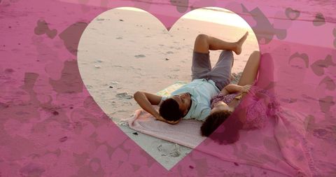 Romantic Couple Relaxing on Beach Under Heart Overlay