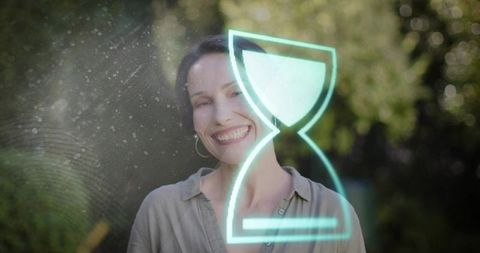 Smiling mature woman in sunlit garden with neon hourglass overlay and floating particles