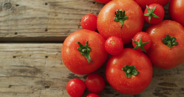 Image of fresh tomatoes and cherry tomatoes with copy space over wooden background - Download Free Stock Photos Pikwizard.com