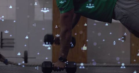 Athlete holding plank while gripping hex dumbbell with smartwatch and social media overlays