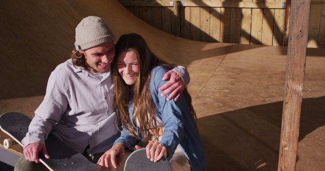 Image of happy caucasian female and male skateboarders in skate park. Skateboarding, sport, active lifestyle and hobby concept.