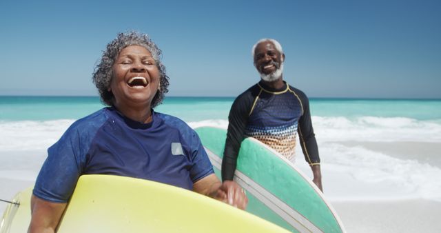 Smiling Senior Couple with Surfboards on Sunny Beach - Download Free Stock Images Pikwizard.com