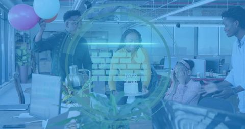 Coworkers celebrating birthday with cake and balloons in modern open office workspace