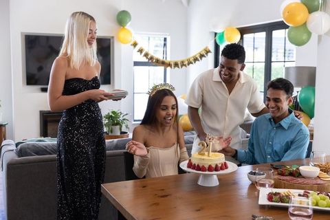 Joyful 21st Birthday Celebration Among Friends with Cake and Banner