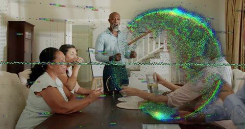 Bearded man leading multigenerational dinner meeting with digital glitch overlay
