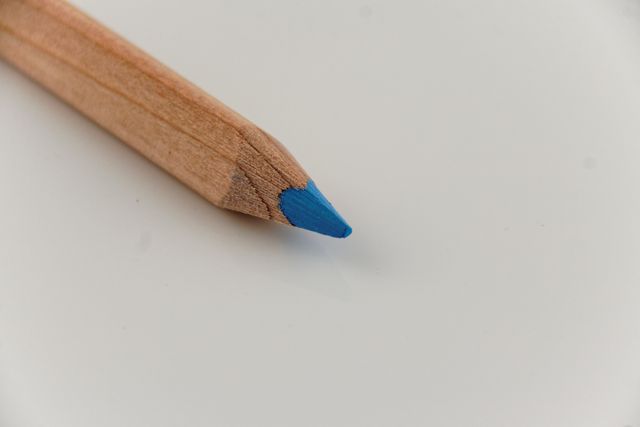 Close-Up of Blue Tipped Wooden Pencil on White Background - Download Free Stock Photos Pikwizard.com