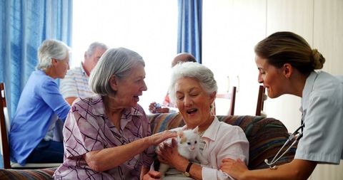 Nurse Interacting with Seniors Enjoying Pet Therapy - Download Free Stock Images Pikwizard.com