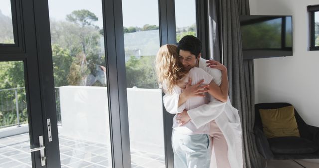 Loving Couple Embracing in Sunlit Modern Home - Download Free Stock Images Pikwizard.com