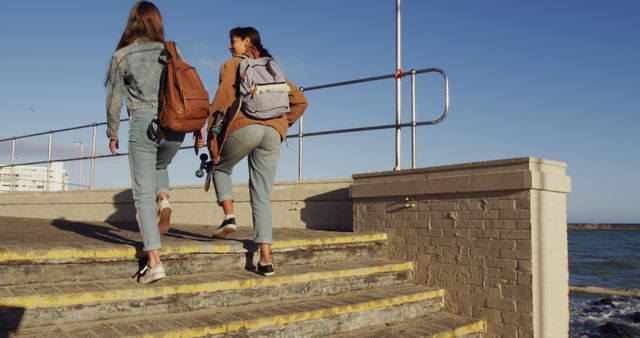 Teen Girls Hiking Upstairs by Seaside with Backpacks on Sunny Day - Download Free Stock Images Pikwizard.com