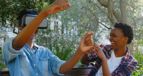 Joyful Twins Exploring Virtual Reality Outdoors in Park
