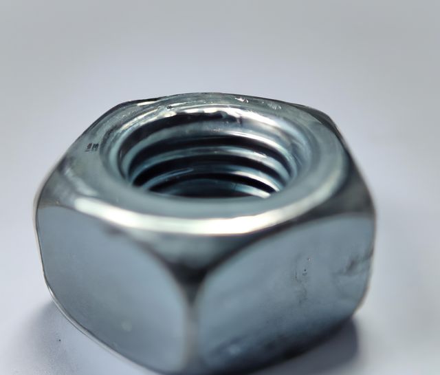 Close-Up of Metallic Hex Nut on White Background - Download Free Stock Images Pikwizard.com