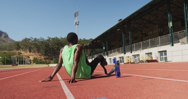 Athlete Resting on Running Track Taking a Break During Training Session - Download Free Stock Images Pikwizard.com