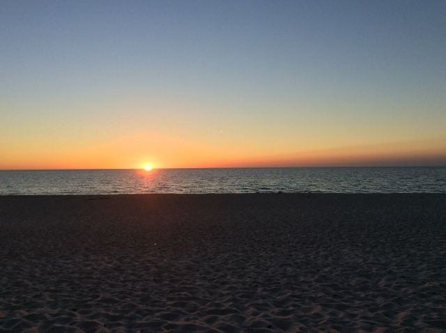 Peaceful Sunset Over Serene Beach with Smooth Horizon - Download Free Stock Photos Pikwizard.com
