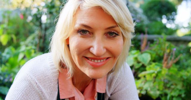 Smiling Middle-Aged Woman Enjoying Nature in Garden - Download Free Stock Images Pikwizard.com